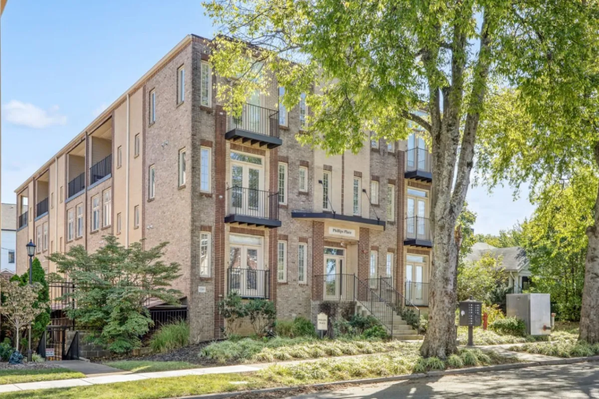 The image shows the exterior of a spacious condo building, highlighting the welcoming main entrance, multiple private balconies perfect for gatherings, and lush greenery surrounding the property. People are seen relaxing on the balconies, enjoying the garden, and strolling through the peaceful neighborhood, creating a lively yet serene atmosphere.