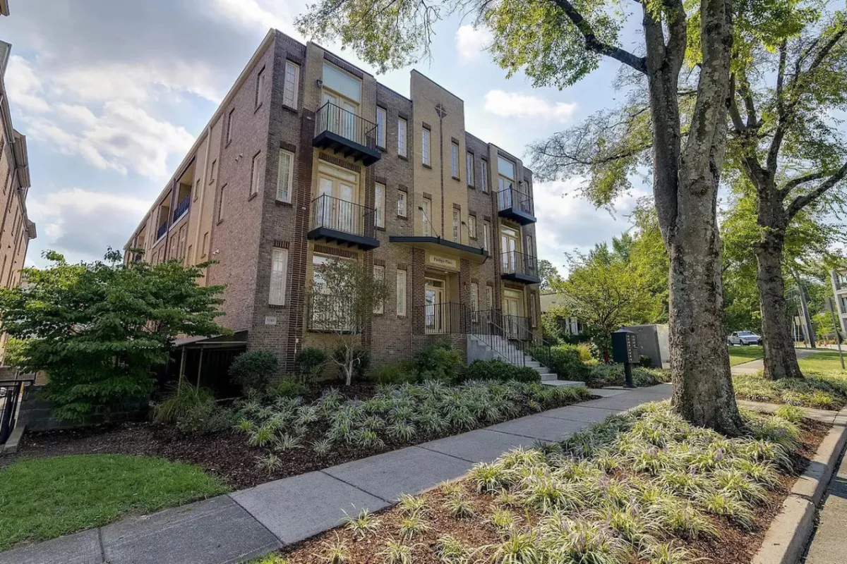 This image displays the modern exterior of the property, highlighting attractive balconies and a landscaped garden area. The architecture is contemporary, and the setting is inviting for social gatherings or stepping out for an evening in the city.