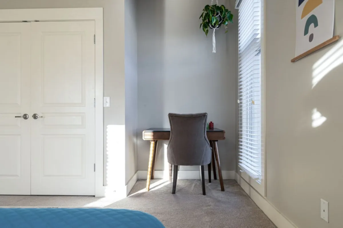 Featuring a desk with a chair, a plant, and light streaming through a window, this image captures a serene and productive workspace. It reflects moments of inspiration and quiet reflection, ideal for business travelers needing a spot to work or hold private meetings.
